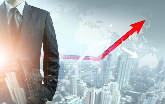 Businessman Point At Increasing Graph And Decreasing Broken Graph With City Background