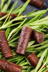 Homemade chocolate candy sticks with rosemary
