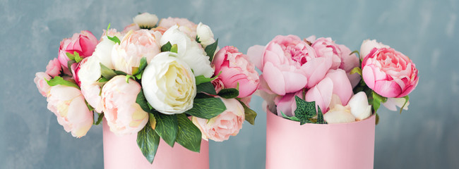 Flowers in round luxury present boxes. Bouquet of pink and white peonies in paper box. Mock-up of...