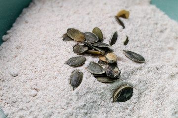 Fototapeta na wymiar Pumpkin seeds in flour