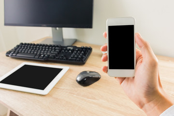 Man using smartphone ,computer pc and tablet on the background