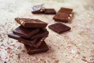 Dark chocolate stack with hazelnuts. Sweet dessert