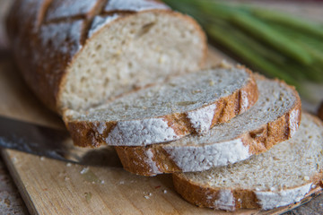 Bread slice on a wooden board. Wheat fresh loaf