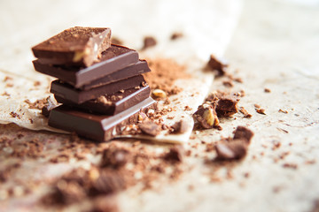 Dark chocolate stack with hazelnuts, selective focus
