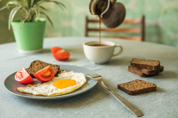 Breakfast fried egg and tomatoes.Coffee from cezve