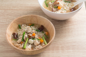 Asian congee with pork in white bowl.