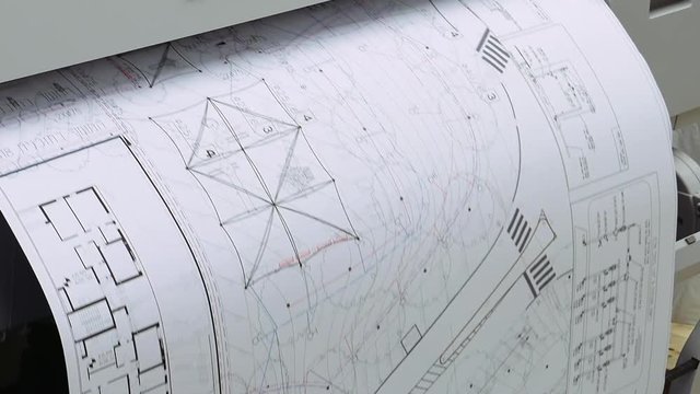 Wide format printer is printing design draft outline sketch drawing in the printing house. Design office supply equipment.