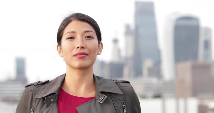 Portrait of businesswoman with London city skyline