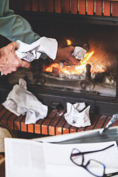 Businessman destroying important documents from case in  fireplace