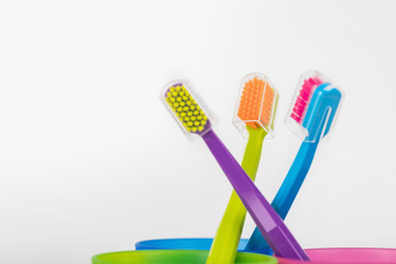 New color ultra fine toothbrushes in colorful glasses. Dental Industry. various types of toothbrushes. Beautiful smile concept. Whitening. Tooth care. Teeth healthy concept.