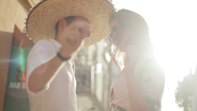 Mexican fiesta street party concept - young attractive people man woman dancing chill entertainment friends love youth feeling emotions drinks cocktails alcohol tequila sombrero moustache shining sun