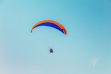Colorful paraglider flying in the  sky.