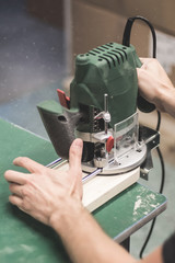 Man cutting wood with a milling machines