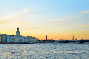 Sunset on the Neva river on the background of the Kunstkamera, the Peter and Paul fortress and Rostral columns