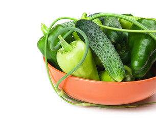 green peppers, cucumbers and garlic in a bowl