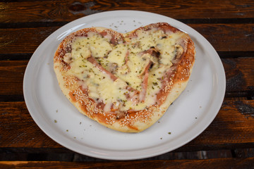 Delicious Heart-shaped pizza on a plate