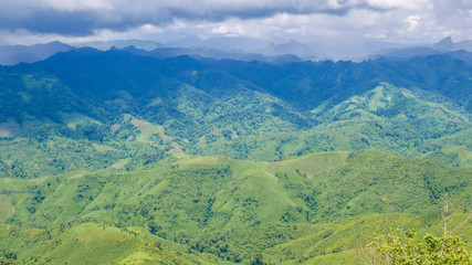 The scenery landscape of the mountains with the background of cloudy sky at the viewpoint along the road from Vang Vieng to Laung Pra bang, Laos.
