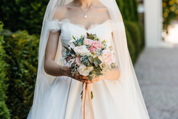 Wedding bouquet in hands of the bride