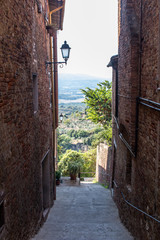 Alley with panoramic view in medieval town of Italy