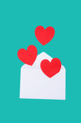 Red heart in a white envelope on a blue background.