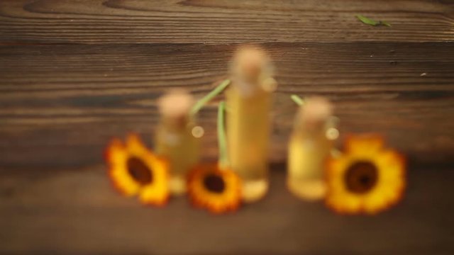 essential oil on table in beautiful bottle with flowers