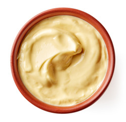 Mayonnaise in clay bowl isolated on white, from above