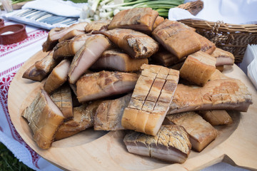 Smoked lard (Slanina) on a wooden plate. Romanian traditional food. 