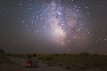 Fototapeta na wymiar couple in love under stars of Milky Way Galaxy 