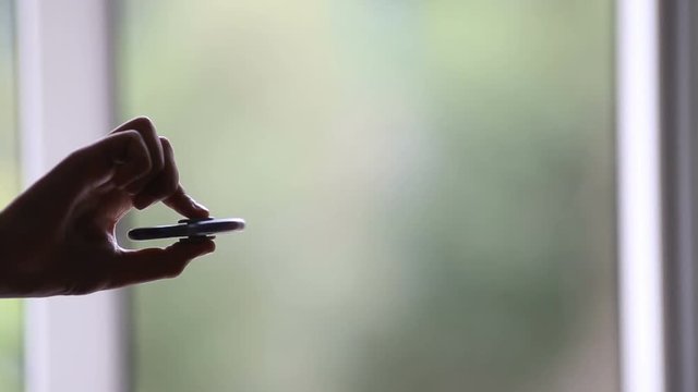 Hand spinner, or fidgeting spinner, rotating on child's hand
