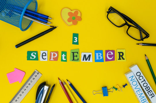 September 3rd. Day 3 of month, Back to school concept. Calendar on teacher or student workplace background with school supplies on yellow table. Autumn time
