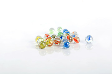glass marbles balls on white background ,selective focus