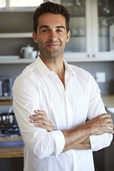 Smiling guy in white shirt in kitchen, portrait