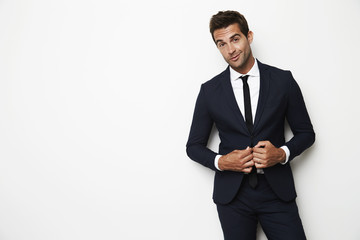 Handsome dude in business suit in white studio