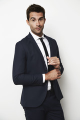 Portrait of handsome guy looking sharp in suit