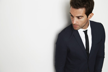 Businessman in smart suit looking away in studio
