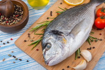 Fresh dorado on blue wooden background