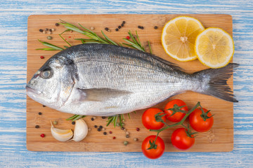 Fresh dorado on blue wooden background
