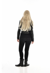 Fototapeta premium full length portrait of blonde girl wearing black leather outfit, standing pose on white background.