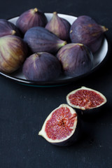 figs in a bowl on a black background