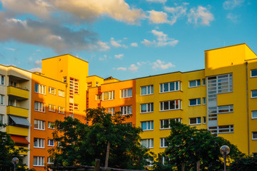 colorful apartment buildings with fluffy clouds