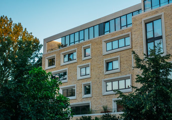 Fototapeta premium modern apartment house with brick facade and clean sky