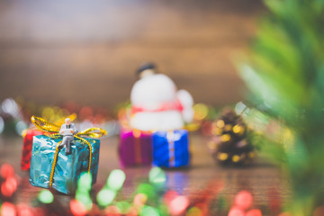 Miniature people on gift box with Christmas Day celebration background