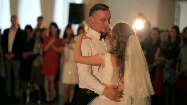 First wedding dance of a young beautiful married couple in love in restaurant. wedding day