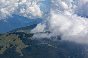 Spectacular view through picturesque clouds from mount Monte Baldo, Garda Lake, Italy