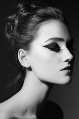 Fototapeta premium Black and white portrait of young beautiful girl with fancy cat eye makeup