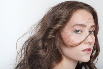 Fototapeta premium Young beautiful girl with long messy curly hair
