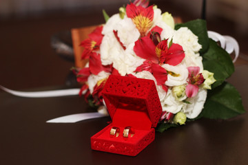 wedding rings on bouquet background © dyageleva