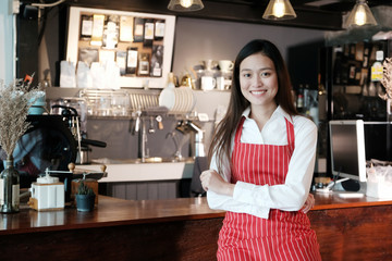 Young asian women Barista standing with smiling face in font of cafe counter background, small business owner, food and drink industry concept