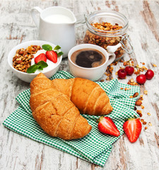 Croissant, coffee, granola  and strawberry