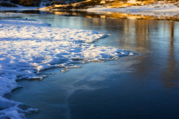Ice and snow on a frozen lake in a winter sunny day